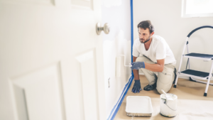 a person painting an interior wall