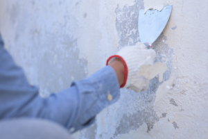 a person removing an older layer of paint