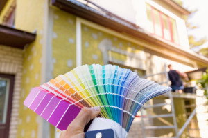 a homeowner choosing a color for their home’s exterior